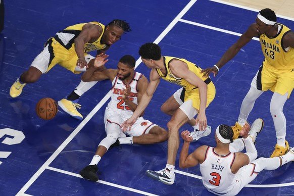 epa12124438 The Knicks Mikal Bridges (2-L) loses control of a loose ball as the Pacers&#039; Aaron Nesmith (L), Ben Sheppard (3-R) and Pascal Siakam (R) defend in the final seconds of overtime of game ...
