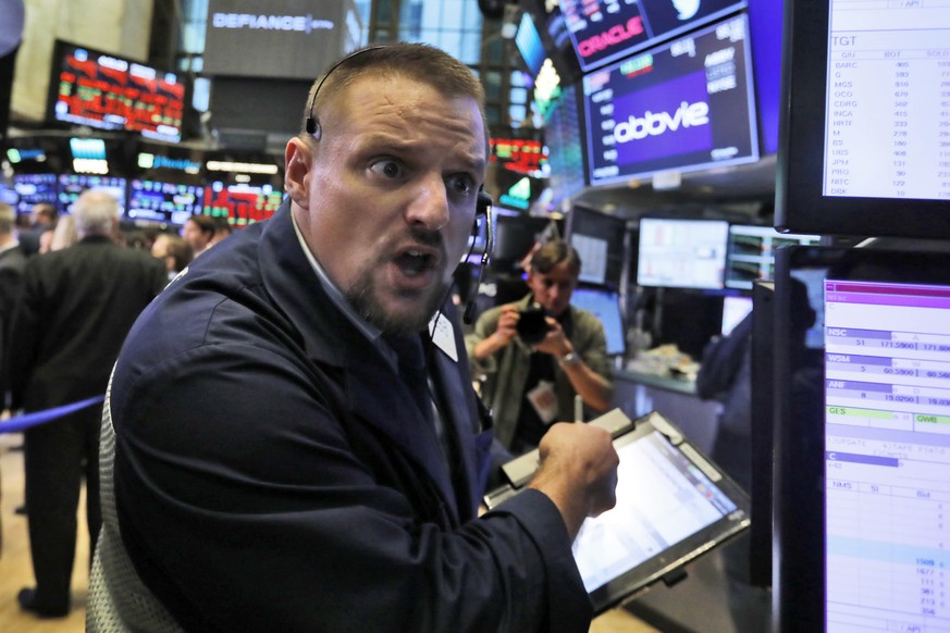 Trader Michael Milano works on the floor of the New York Stock Exchange, Wednesday, Oct. 10, 2018. Stocks are extending their slump on Wall Street, led by drops in big technology companies, as rising  ...