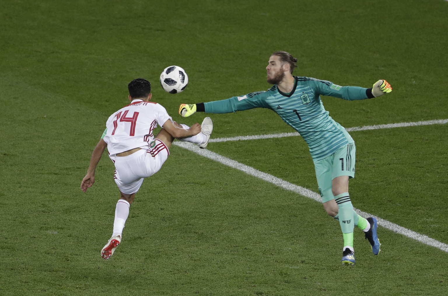 Spain goalkeeper David De Gea, right, makes a save in front of Morocco&#039;s Mbark Boussoufa during the group B match between Spain and Morocco at the 2018 soccer World Cup in the Kaliningrad Stadium ...