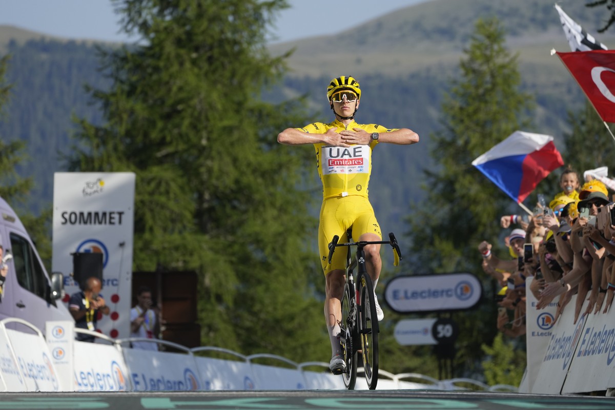 Slovenia's Tadej Pogacar, wearing the overall leader's yellow jersey, crosses the finish line to take his fifth stage win during the twentieth stage of the Tour de France cycling race over 1 ...