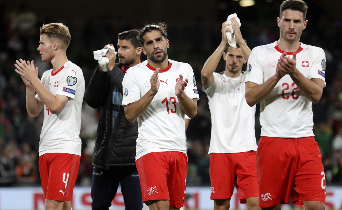 Switzerland's Ricardo Rodriguez, center and Fabian Schar, right, applaud the supporters at the end of the Euro 2020 group D qualifying soccer match between Ireland and Switzerland at the Aviva st ...