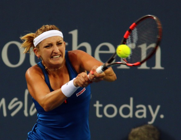 Timea Bacsinszky, of Switzerland, returns the ball to Madison Keys, of the USA, at the Western &amp; Southern Open tennis tournament, Monday Aug. 17, 2015, in Mason, Ohio. (AP Photo/Tom Uhlman)