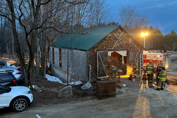 Firefighters work at a building in Tamworth, New Hampshire, where the floor collapsed during a wedding Saturday, March 21, 2026. State Fire Marshal's Office investigators believe a building was o ...