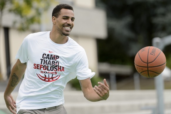 Atlanta Hawks NBA basketball player Thabo Sefolosha from Switzerland plays basketball with kids of the basketball Camp Thabo Sefolosha after a press conference, in Blonay, Switzerland, Wednesday, July ...