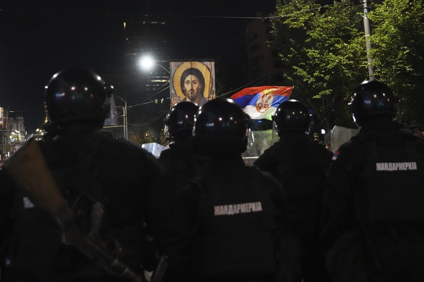 Serbian gendarmerie officers guard the street during an anti-government protest near Serbian Progressive Party office in Belgrade, Serbia, Friday, Aug. 15, 2025. (AP Photo/Darko Vojinovic)