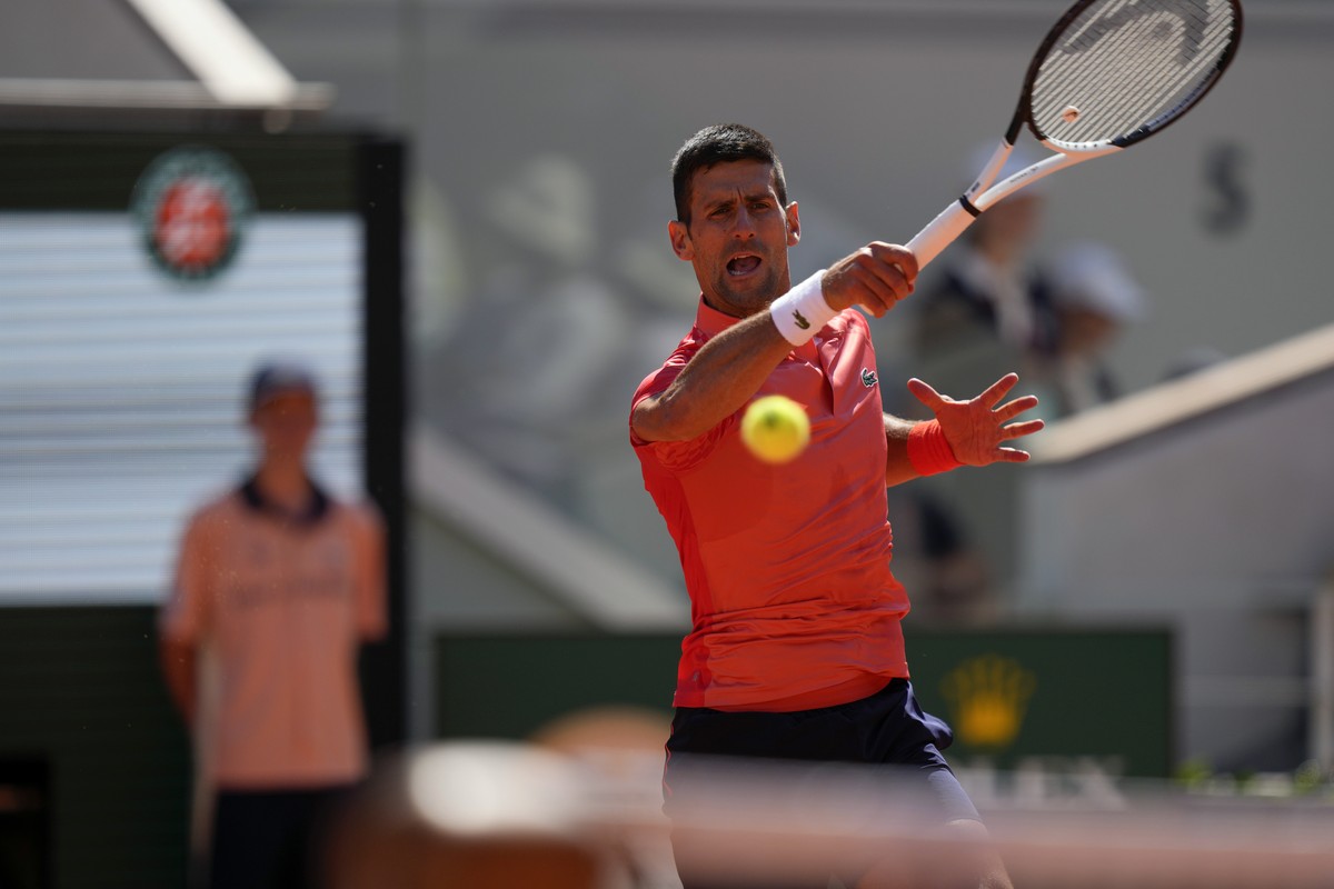 Serbia's Novak Djokovic plays a shot against Peru's Juan Pablo Varillas during their fourth round match of the French Open tennis tournament at the Roland Garros stadium in Paris, Sunday, Ju ...