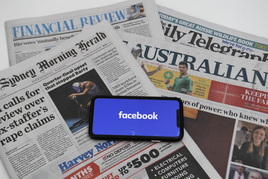 epa09020239 An illustration image shows a phone screen with the Facebook logo and Australian Newspapers at Parliament House in Canberra, Australia, 18 February 2021. Social media giant Facebook has mo ...