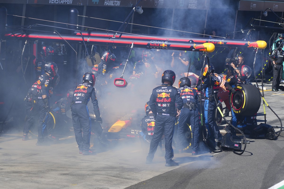 Mechanics work to extinguish a fire in Red Bull driver Max Verstappen of the Netherlands' car during the Australian Formula One Grand Prix at Albert Park, in Melbourne, Australia, Sunday, March 2 ...