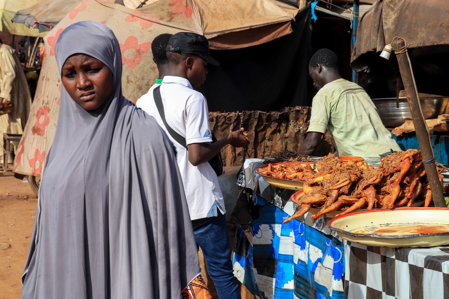 epa10775903 Shoppers visit a street a market in Niamey, Niger, 29 July 2023. The city was calm after General Abdourahamane Tchiani, head of the Presidential Guard since 2011, was declared the new lead ...