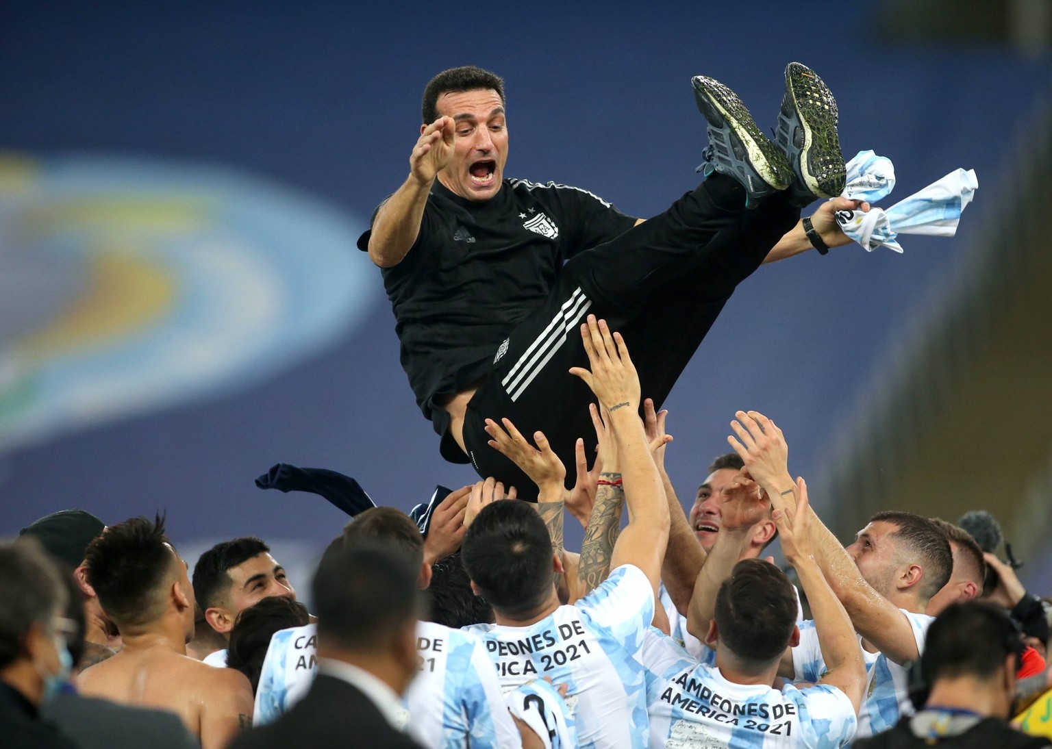 RIO DE JANEIRO, BRAZIL - JULY 10: Players of Argentina lift in the air their Head Coach Lionel Scaloni after winning the Final of Copa America Brazil 2021 ,during the Final Match between Brazil and Ar ...