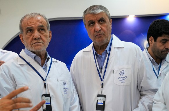 epa12498659 A handout photo made available by the Iranian Atomic Organization office (AEOI) shows Iranian President Masoud Pezeshkian (L) and head of Iran&#039;s Atomic Energy Organization Mohammad Es ...