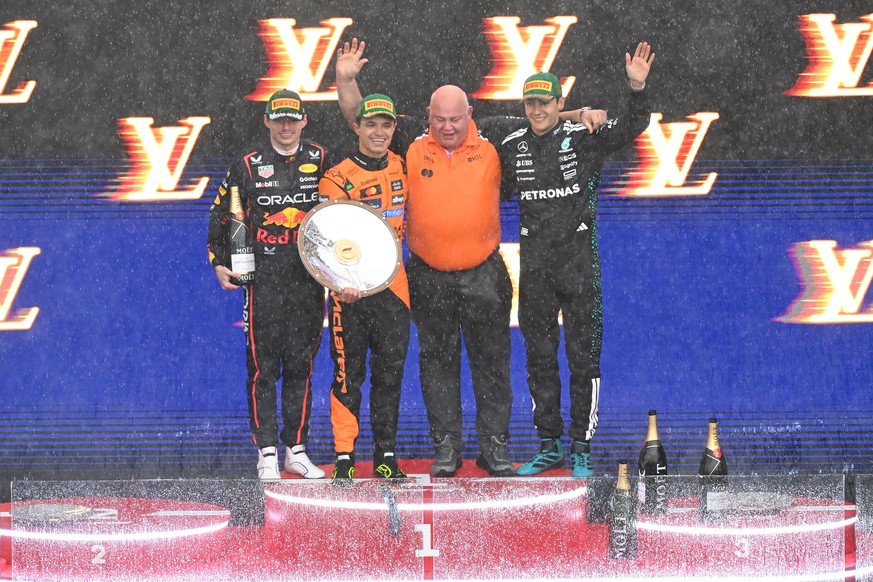 epa11967539 Max Verstappen (L) of Red Bull Racing, Lando Norris (2-L) of McLaren and George Russell (R) of Mercedes celebrate on the winners podium during the trophy ceremony for the Australian Grand  ...