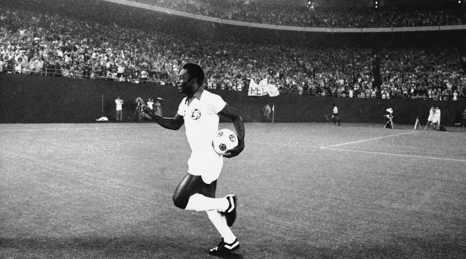 New York Cosmos star Pele runs onto field after his introduction before a crowd of 73,669 prior to game between Cosmos and Rochester Lancers at night on Wednesday, August 25, 1977 in Giants Stadium, E ...