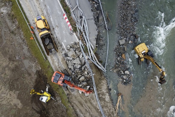 epa11436518 An aerial view shows repair works on the highway A13 between Lostallo and Soazza destroyed by the force of the Moesa river, caused by heavy rain in the Misox valley, in Lostallo, southern  ...