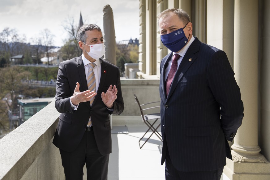 Ignazio Cassis, Swiss Minister of Foreign Affairs, left, and Vladimir Makei, Belarusian Minister of Foreign Affairs, discuss on the balcony of the government building prior to a meeting in Bern, Switz ...