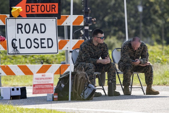 Marines sit under a tent at a checkpoint along Old Georgetown Road, Tuesday, Sept. 19, 2023, in Williamsburg County, S.C., about 60 miles (96 km) northeast of Joint Base Charleston where a recovery op ...