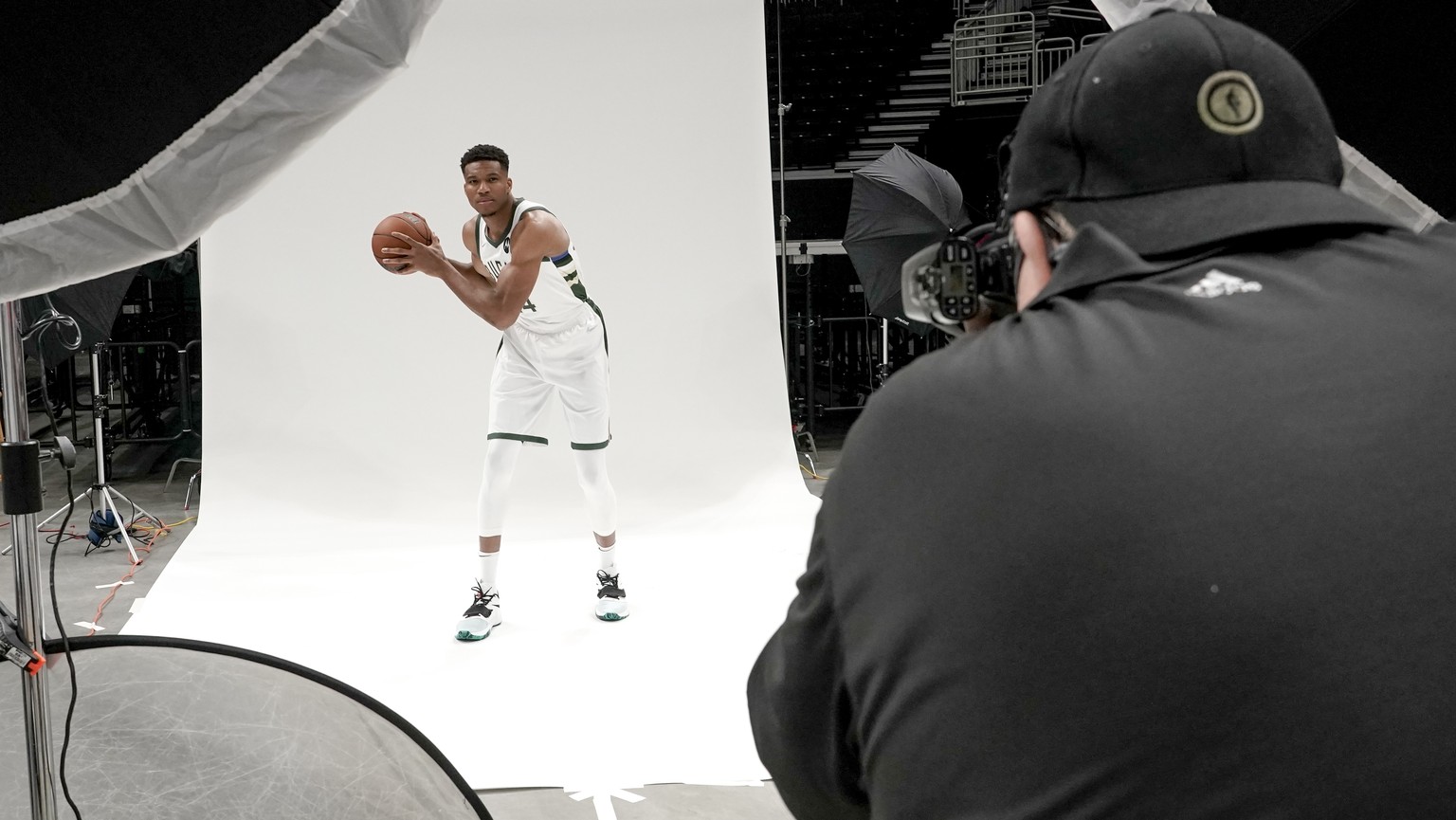 Milwaukee Bucks&#039; Giannis Antetokounmpo poses for team photographer Gary Dineen during an NBA basketball media day Monday, Sept. 27, 2021, in Milwaukee. (AP Photo/Morry Gash)