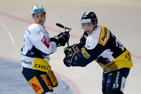 Ambri&#039;s player Michael Fora right, fights for the puck with Zug&#039;s player Grégory Hofmann left, during the preliminary round game of National League A (NLA) Swiss Championship 2019/20 between ...