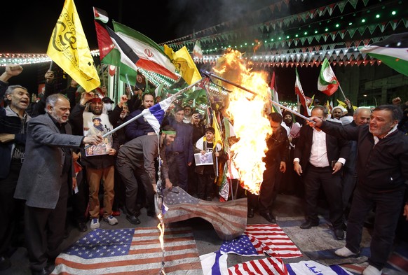 epa11254914 Iranians burn Israel and US flags during an anti-Israeli demonstration at Palestine Square in Tehran, Iran, 01 April 2024. According to IRNA News Agency, Israel on 01 April launched an air ...