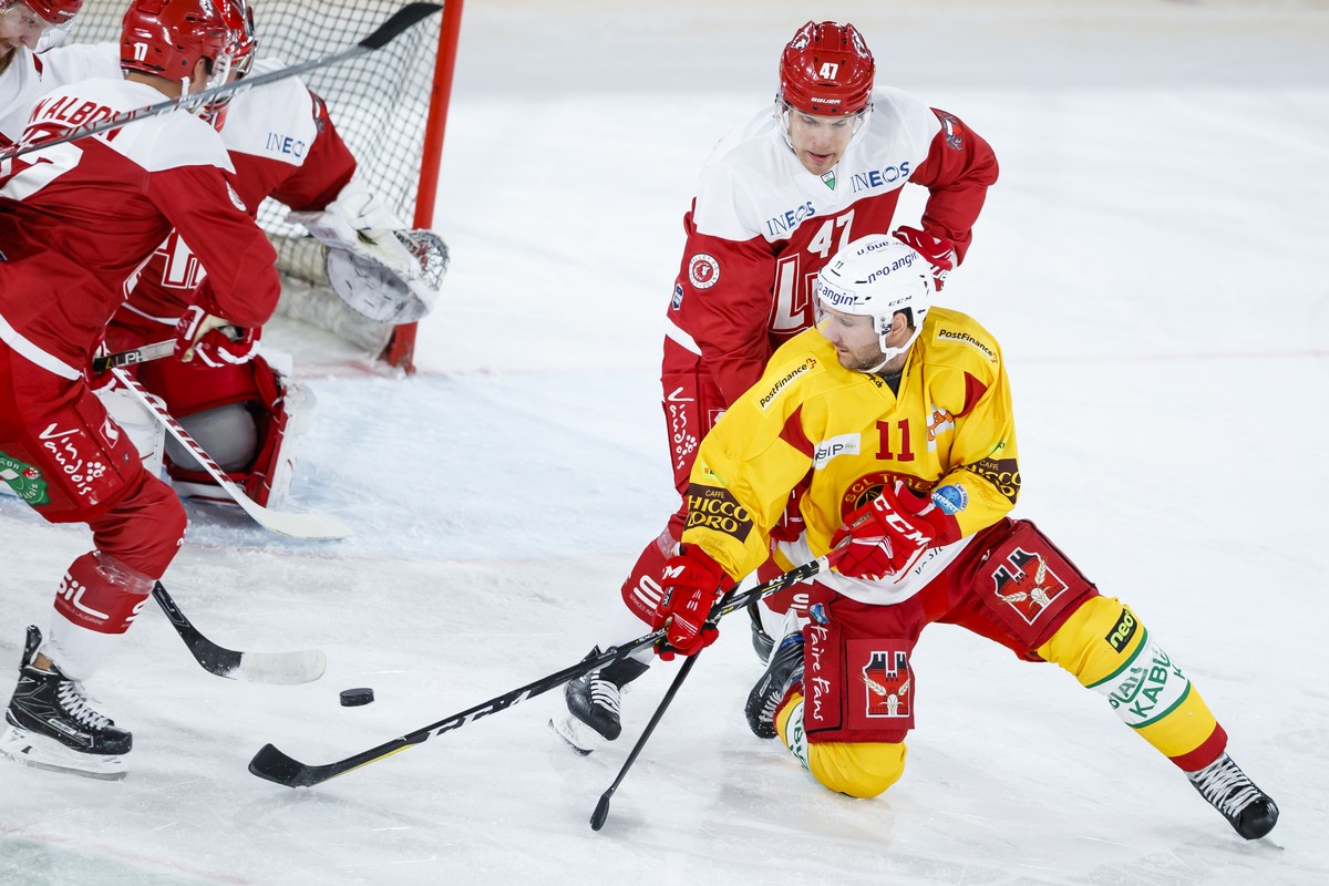 L'attaquant lausannois Philippe Schelling, haut droite, lutte pour le puck avec l'attaquant de Langnau Aaron Gagnon, bas droite, lors de la rencontre du championnat suisse de hockey sur glac ...
