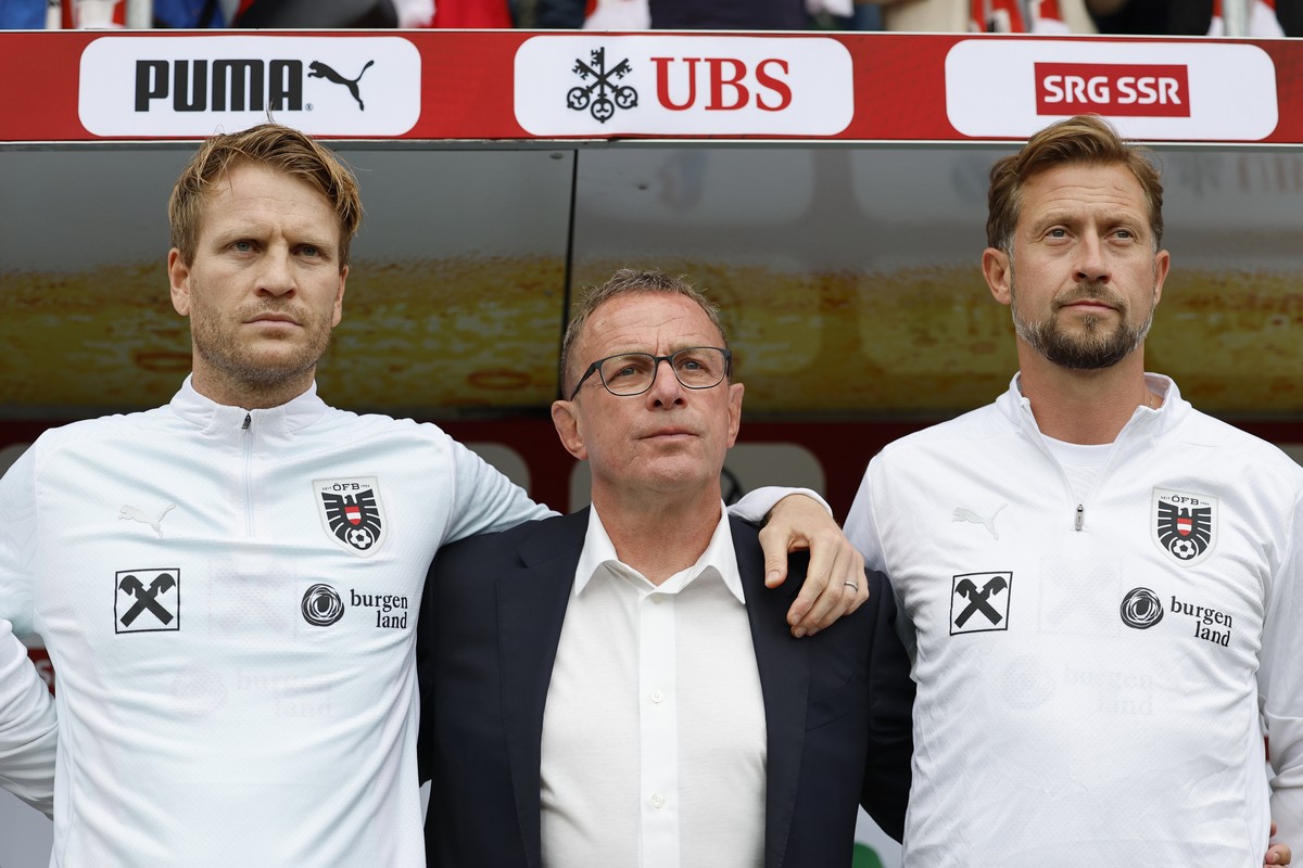 Austria's head coach Ralf Rangnick, center, and his assistent coaches Peter Perchtold, left, and Lars Kornetka listen to the national anthems prior to an international friendly soccer match betwe ...