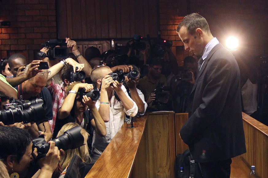 FILE - Photographers take pictures of Olympic athlete Oscar Pistorius as he appears at a bail hearing for the shooting death of his girlfriend Reeva Steenkamp, in Pretoria, South Africa, on Feb 22, 20 ...