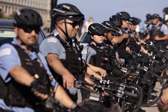 epa11554696 Police stand on duty downtown near a demonstration ahead of the Democratic National Convention (DNC) in Chicago, Illinois, USA, 18 August 2024. The Democratic National Convention is due to ...