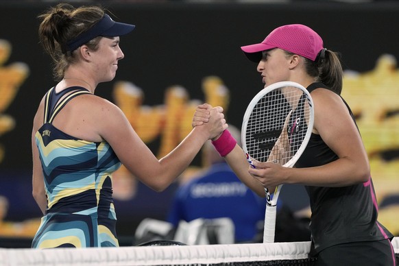 Linda Noskova, left, of the Czech Republic is congratulated by g Iga Swiatek of Poland following their third round match at the Australian Open tennis championships at Melbourne Park, Melbourne, Austr ...