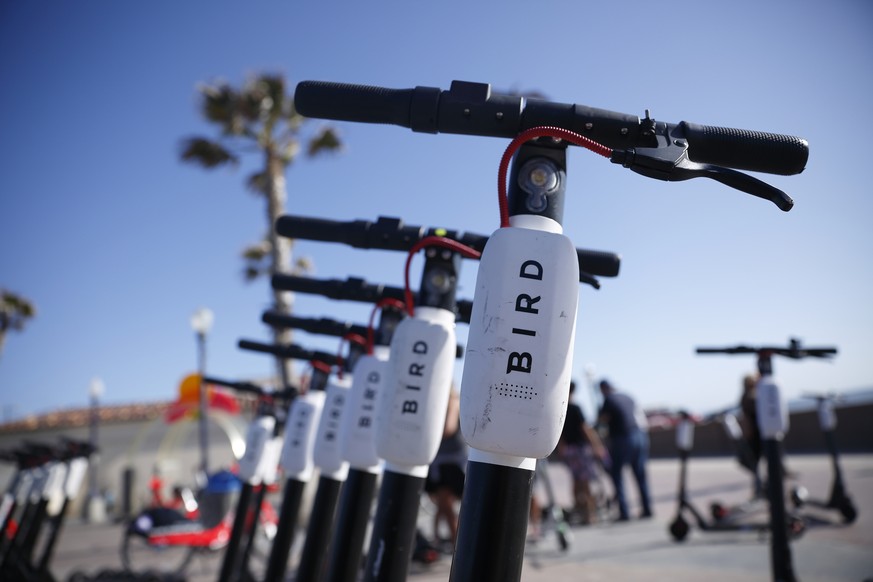FILE - In this May 28, 2019, file photo Bird scooters are seen along Mission Beach boardwalk in San Diego. The two largest scooter companies in the U.S., Bird and Lime, generally place the responsibil ...