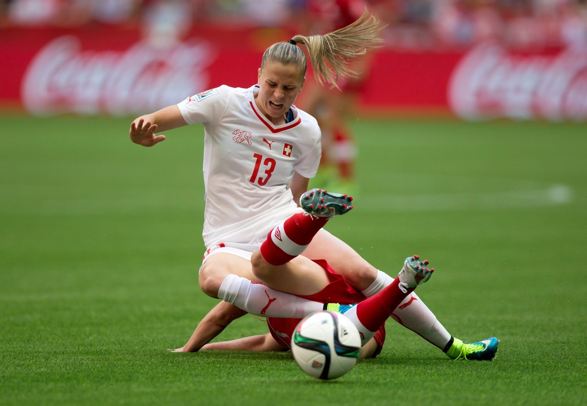 Switzerland's Ana Maria Crnogorcevic (13) and Canada's Allysha Chapman collide during the first half of the FIFA Women's World Cup soccer action in Vancouver, British Columbia, Canada,  ...
