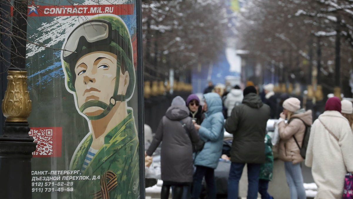 epa10550918 A billboard depicts a soldier with the slogan 'Serving Russia is a real job' in St. Petersburg, Russia, 30 March 2023. On 24 February 2022 Russian troops entered the Ukrainian te ...