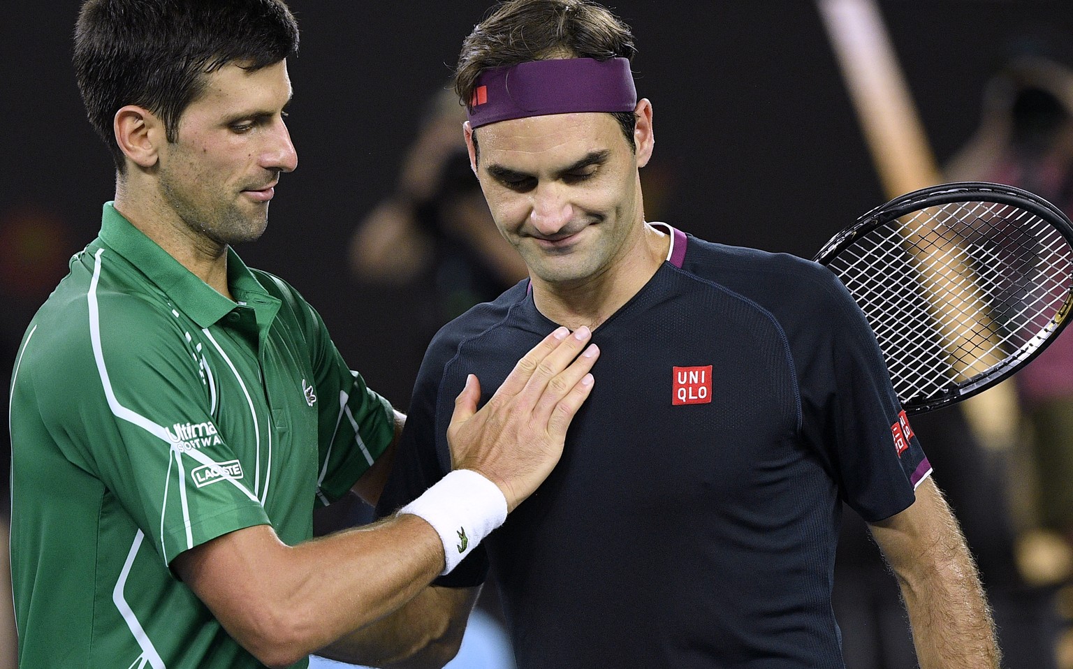 Switzerland&#039;s Roger Federer, right, congratulates Serbia&#039;s Novak Djokovic on winning their semifinal match at the Australian Open tennis championship in Melbourne, Australia, Thursday, Jan.  ...