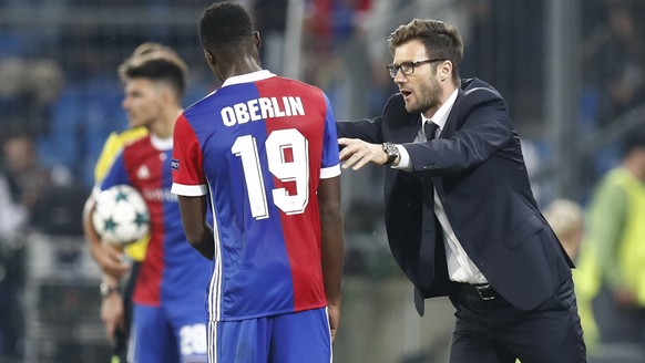 Basel&#039;s Dimitri Oberlin, left, and his head coach Raphael Wicky interact during an UEFA Champions League Group stage Group A matchday 2 soccer match between Switzerland&#039;s FC Basel 1893 and P ...