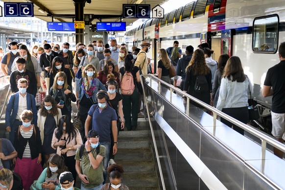 People wearing protective mask get out a SBB CFF train during the coronavirus disease (COVID-19) outbreak, at the train station CFF in Lausanne, Switzerland, Monday, July 6, 2020. In Switzerland, from ...