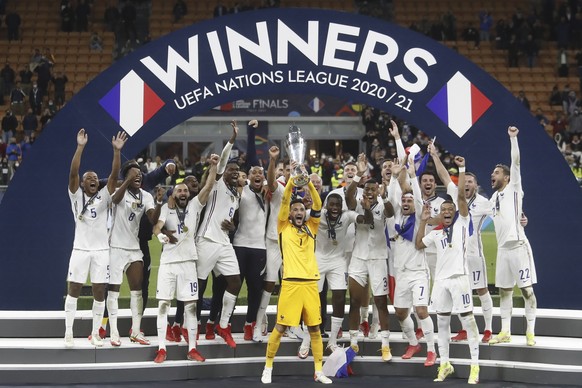 epa09517636 Players of France celebrate with the trophy after winning the UEFA Nations League final soccer match between Spain and France in Milan, Italy, 10 October 2021. EPA/MATTEO BAZZI