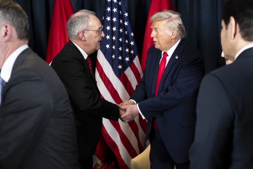 KEYPIX - Switzerland's Federal President Guy Parmelin, center-left, welcomes US President Donald Trump, center-right, prior to a bilateral meeting in Congress Centre on the sideline of the 56th a ...