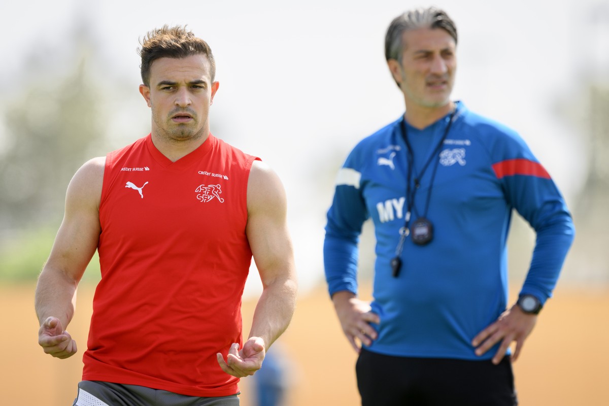 Switzerland's midfielder Xherdan Shaqiri, left, and Switzerland's head coach Murat Yakin, right, attend a closed training session of Swiss national soccer team in preparation for the FIFA Wo ...