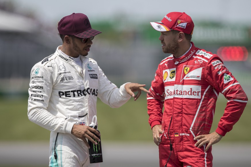 epa06021586 British Formula One driver Lewis Hamilton of Mercedes AMG GP (L) talks to German Formula One driver Sebastian Vettel of Scuderia Ferrari (R) after the qualifying session of Canada Formula  ...