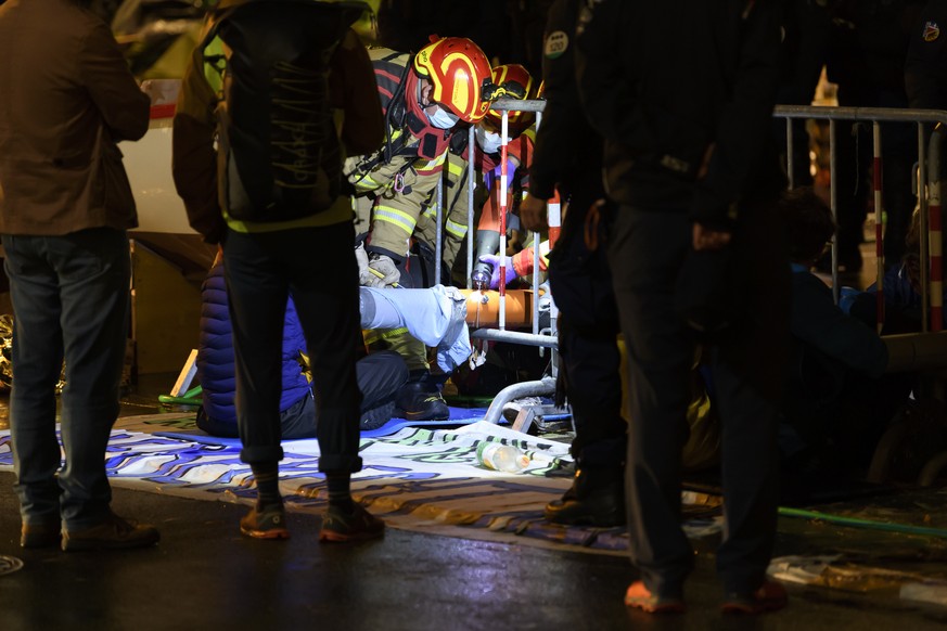 Firefighters release activists for the climate from their chaining to a barrier during their ?Rise up for Change? week of action in front of the Swiss parliament building, the ??Bundeshaus??, where th ...