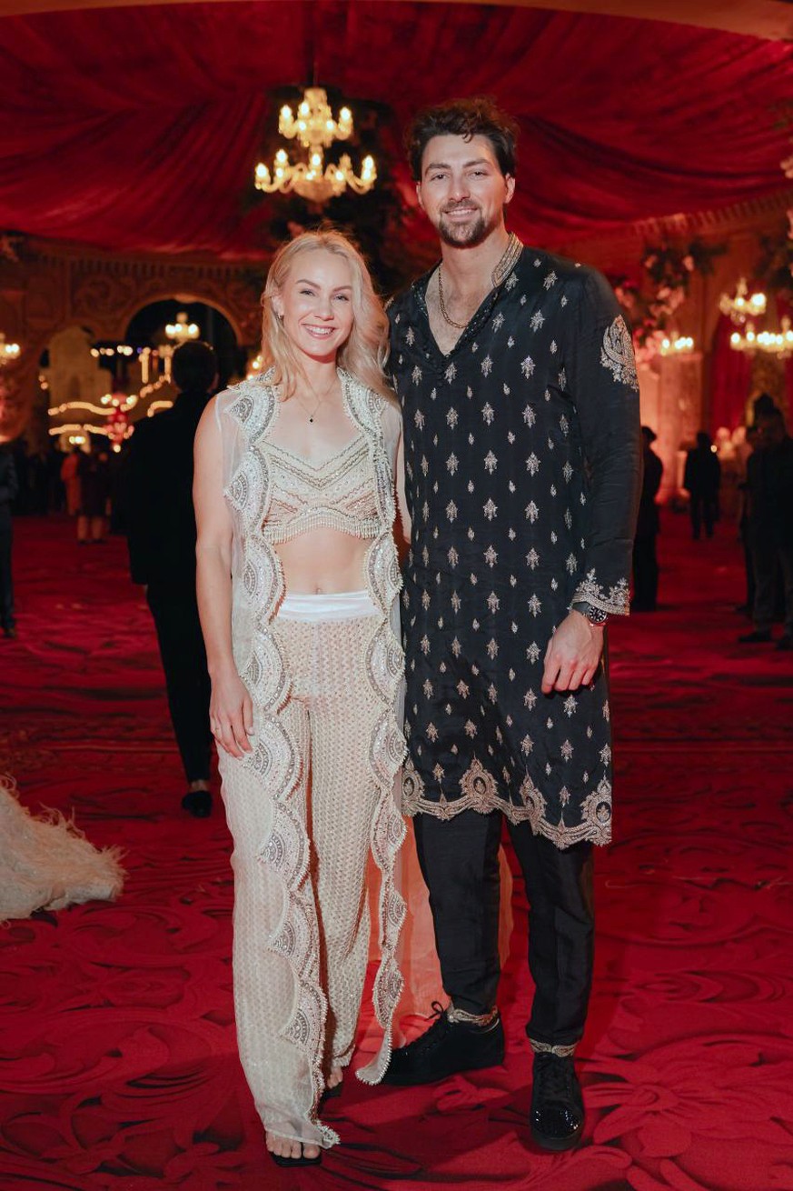 This photo released by the Reliance group shows Australian cricketer Tim David and his wife Stephanie Kershaw posing for a photo during a pre-wedding function of Mukesh Ambani's son Anant Amban...