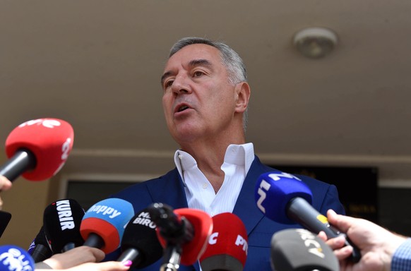 epa10685530 Former President of Montenegro Milo Djukanovic talks to the media after casting his vote in the parliamentary elections in Podgorica, Montenegro, June 11, 2023. Montenegro votes in an instant...