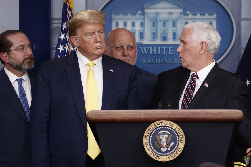 Vice President Mike Pence turns to President Donald Trump as he speaks in the briefing room of the White House in Washington, Monday, March, 9, 2020, about the coronavirus outbreak as Health and Human ...