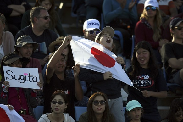 epa06439882 Japanese fans react during the match between Jack Sock of the USA and Yuichi Sugita of Japan during round one of the Australian Open tennis tournament in Melbourne, Australia, 15 January 2 ...