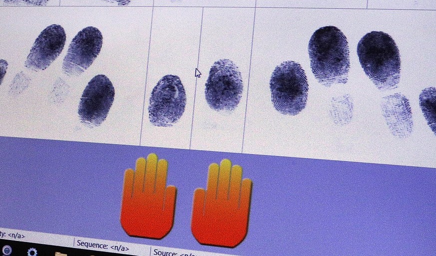 A technician at FIRM Systems demonstrates how finger prints are scanned and captured using Livescan biometric fingerprint technology Monday, June 6, 2016, in Springfield, Ill. Among those that the dea ...