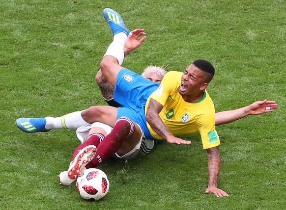 epa06858020 Gabriel Jesus (front) of Brazil in action against Carlos Salcedo (back) of Mexico during the FIFA World Cup 2018 round of 16 soccer match between Brazil and Mexico in Samara, Russia, 02 Ju ...