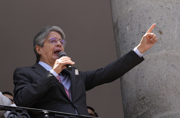 Ecuadorian President Guillermo Lasso talks to supporters from Carondelet government palace in Quito, Ecuador, Tuesday, Oct. 12, 2021. Lasso is one of hundreds of current and former politicians identif ...