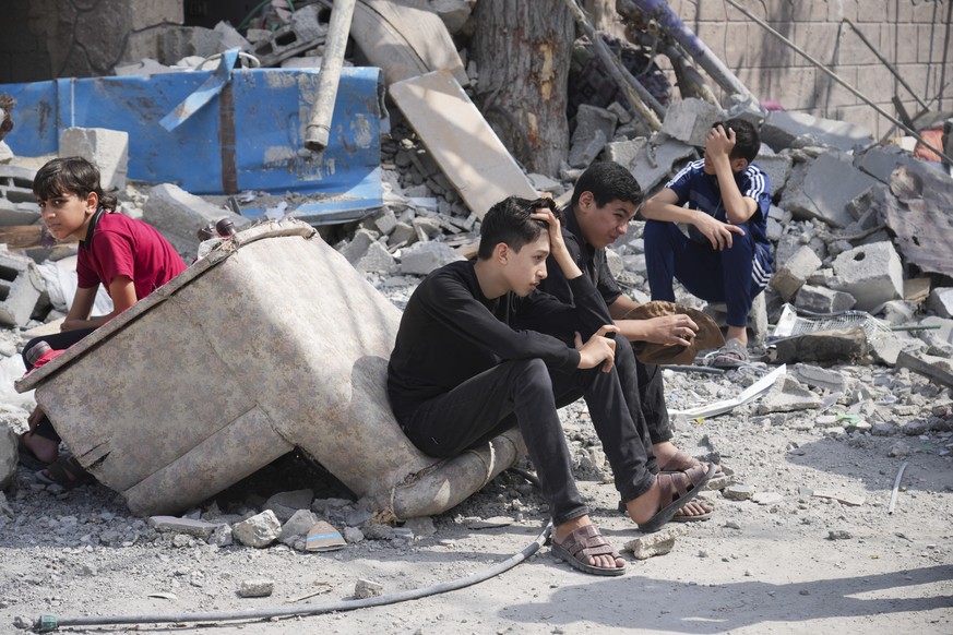 FILE - Palestinian boys sit on the rubble of a building destroyed during an Israeli airstrike in the Nuseirat camp in the central Gaza Strip on Monday, October 8.  August 16, 2023. The need to testify, the journalists ...