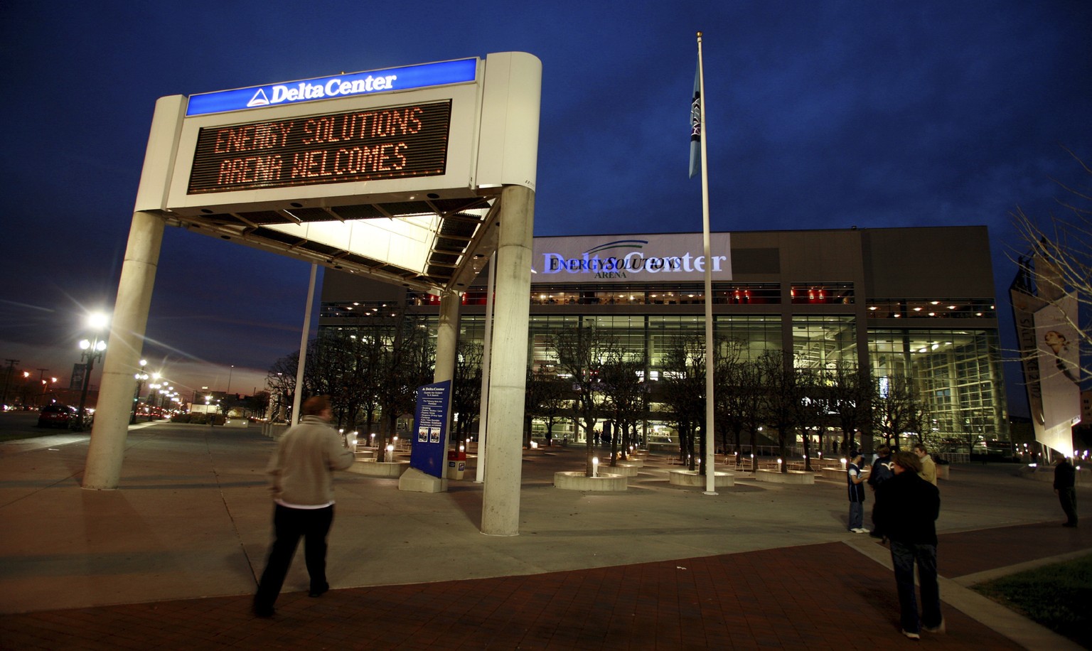 FILE - The marquee in front of the Energy Solutions Arena, formerly the Delta Center, home of the Utah Jazz, shows conflicting signage at dusk before a game against the Toronto Raptors, Monday, Nov. 2 ...