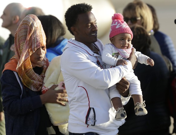 A family with a baby disembarks from an Italian military aircraft arriving from Misrata, Libya, at Pratica di Mare military airport, near Rome, Monday, April 29, 2019. Italy organized a humanitarian e ...