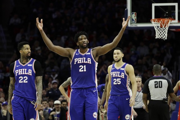 Philadelphia 76ers' Joel Embiid (21) reacts after drawing a foul as Wilson Chandler (22) and Ben Simmons look on during the first half of an NBA basketball game against the Houston Rockets, Monday, Ja ...